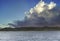 Fishing boat sailing on the Tokyo Bay with a huge dramatic cloud on BÅsÅ Peninsula.